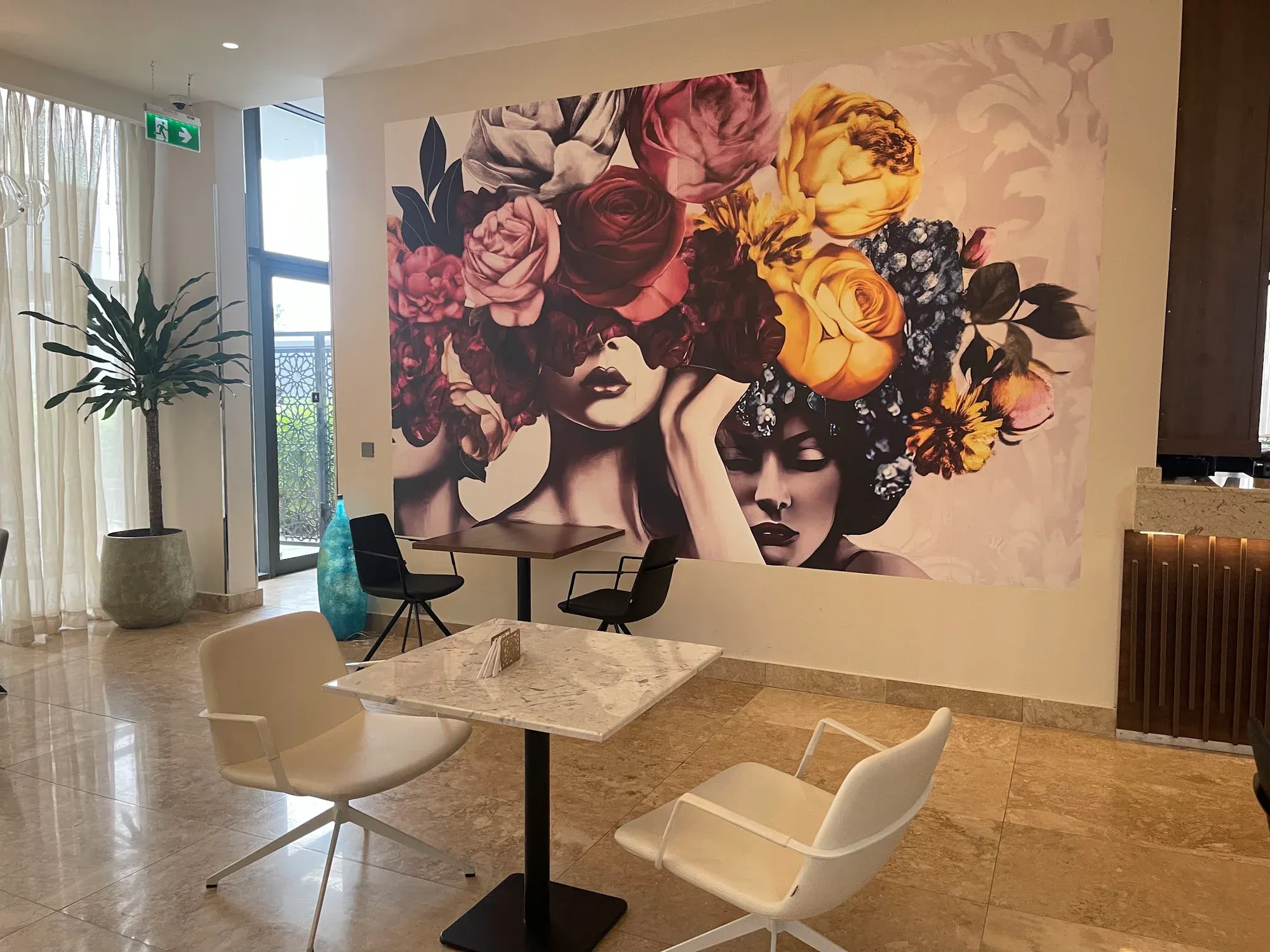 Angled view of the Albergo Hotel lobby mural and surrounding seating