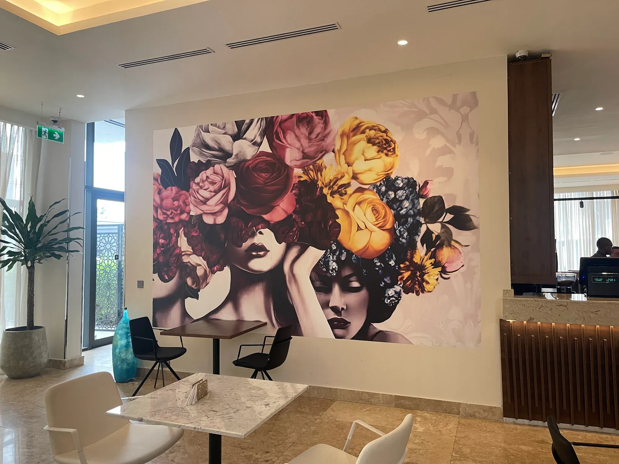 Albergo Hotel lounge and dining area arranged around a floral portrait mural