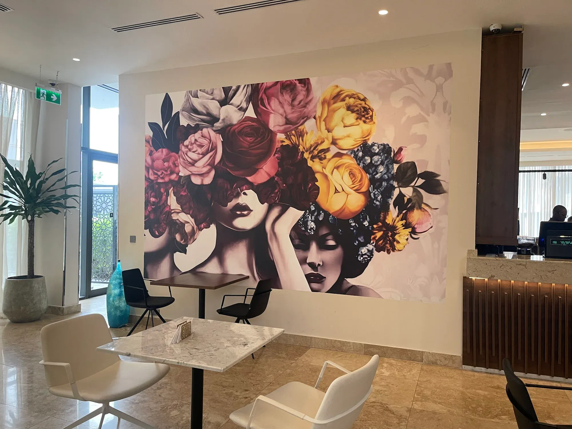 Large floral portrait mural spanning the Albergo Hotel lobby