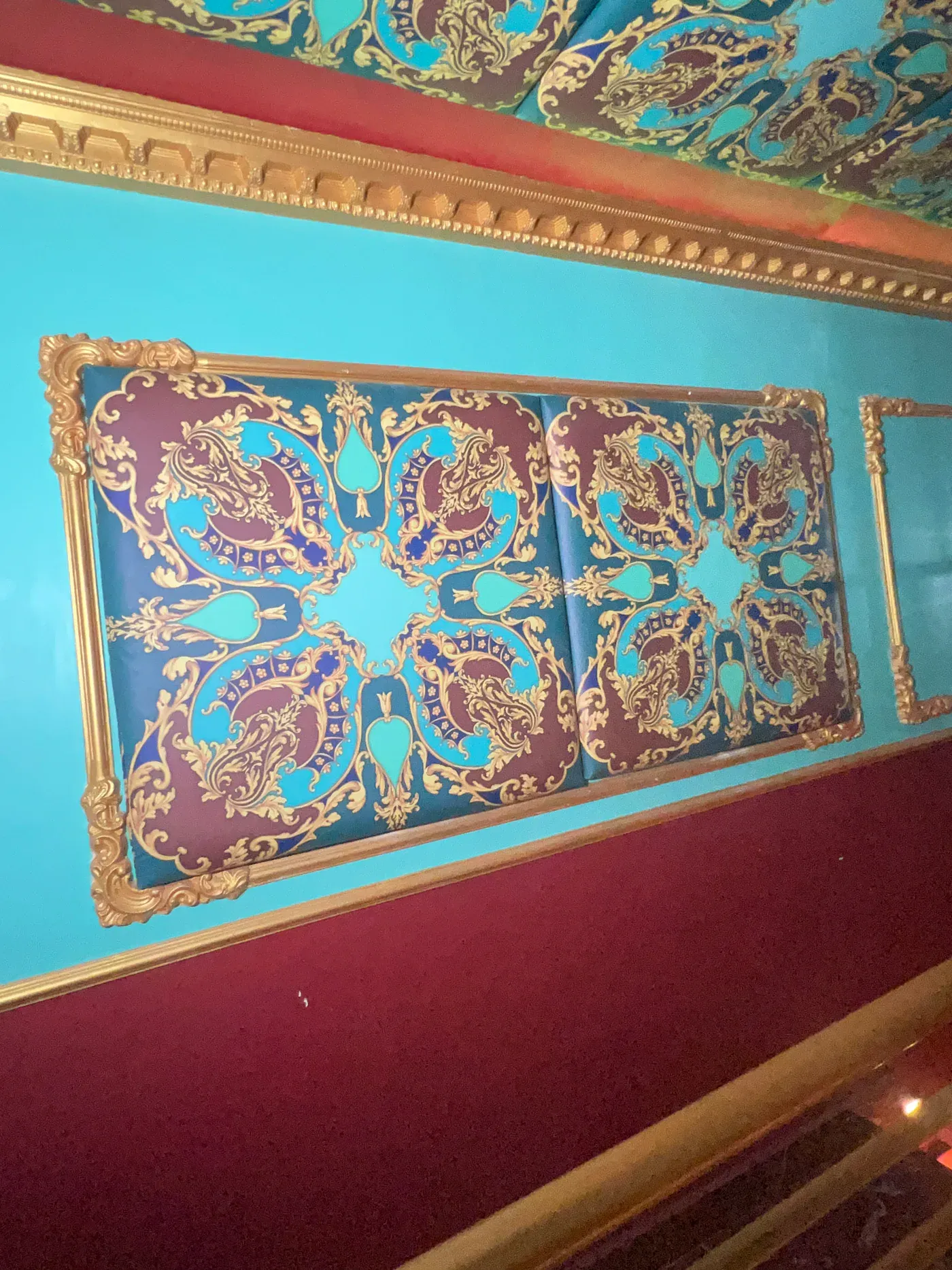 Club Boho wall treatment beneath its patterned ceiling