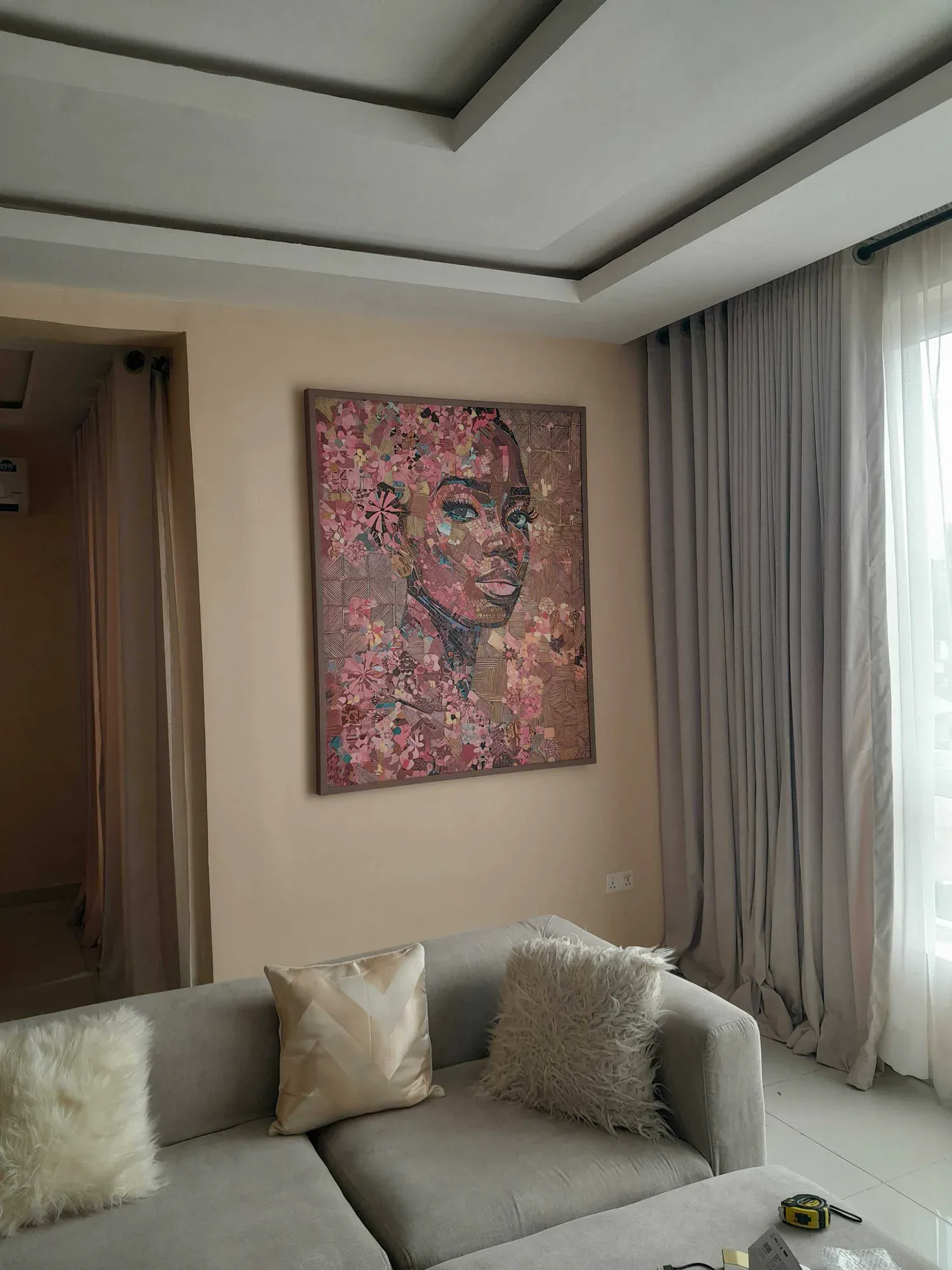Damis Portrait installed above a console in a private living room
