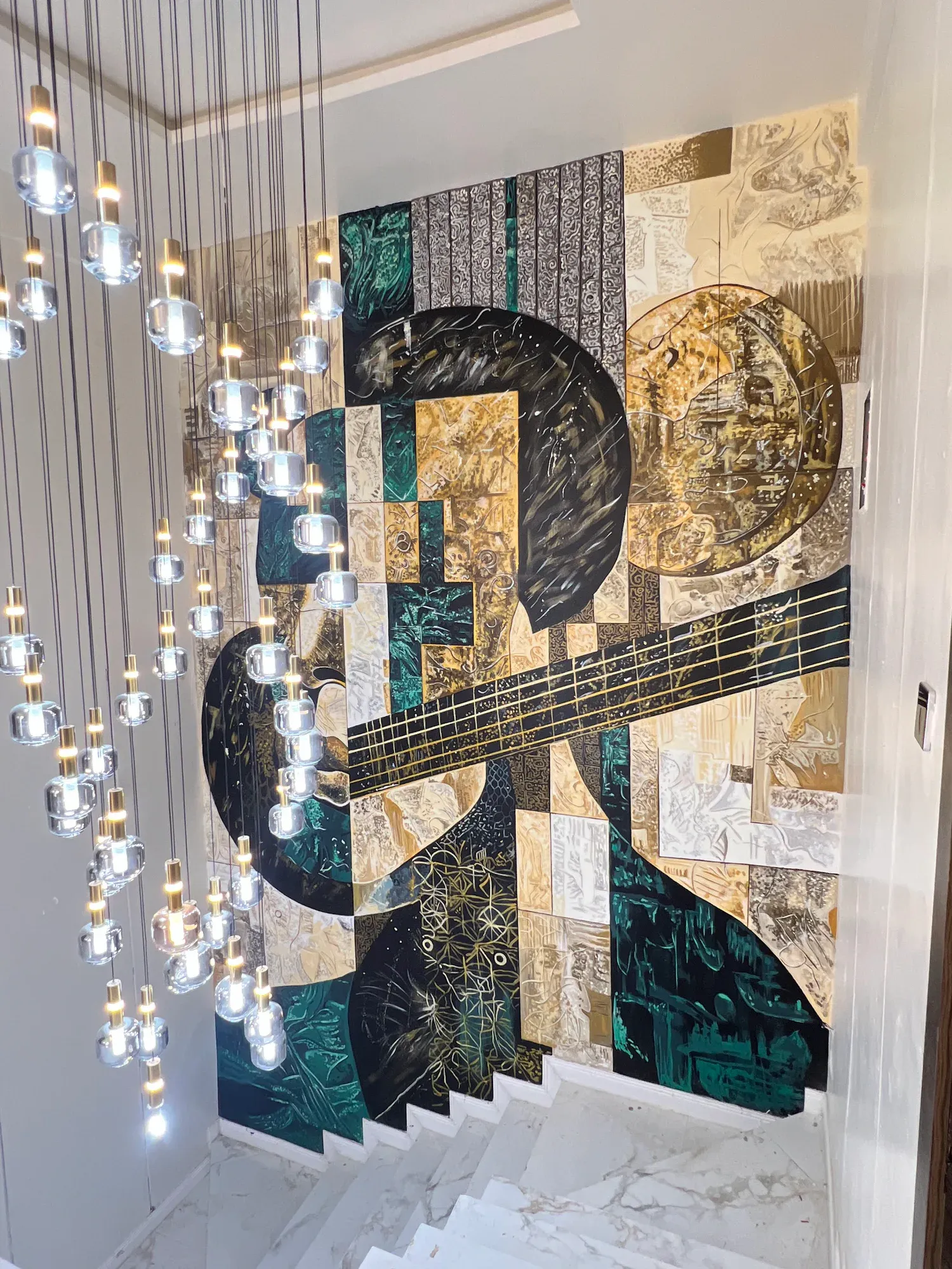 Angled view of the Giran mural across the private stairwell