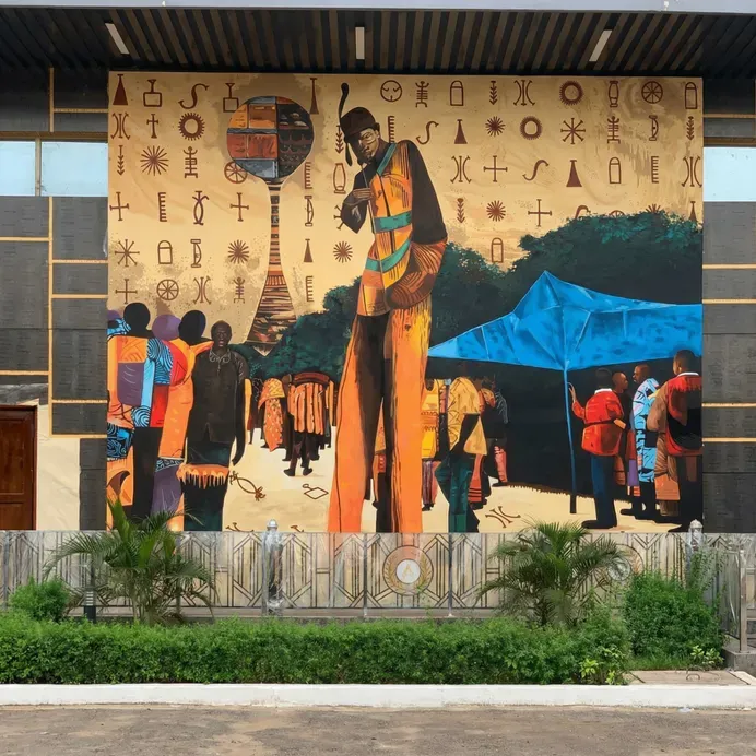 Large hand-painted Okija mural integrated into the resort architecture
