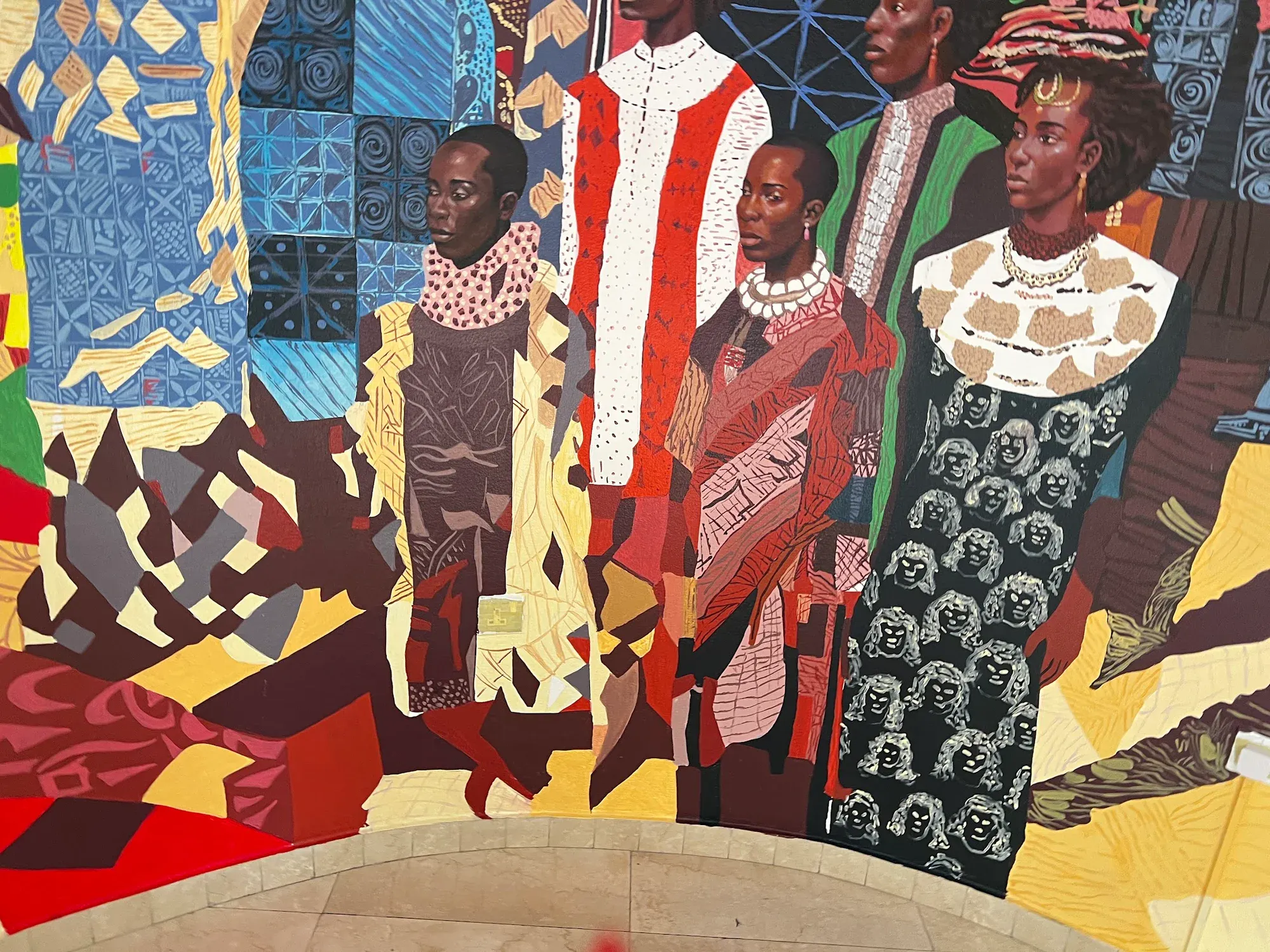 Close view of a figure and cultural pattern at The Wheatbaker
