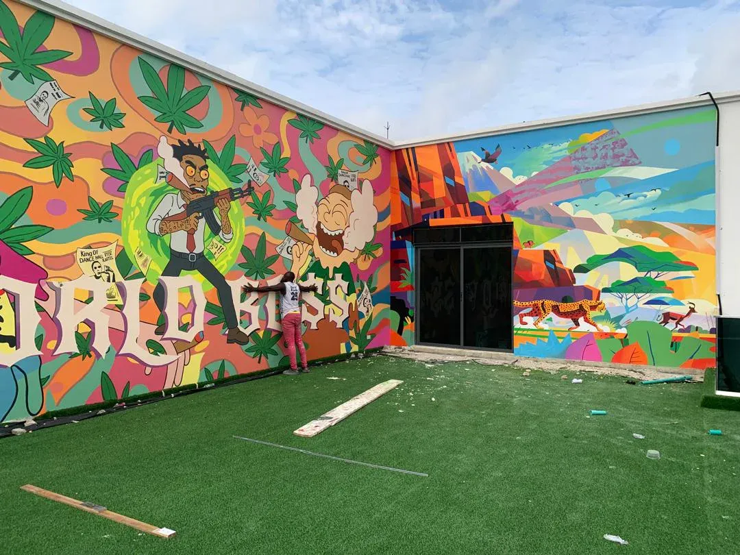 Right section of the World Bo$$ mural wrapping a courtyard