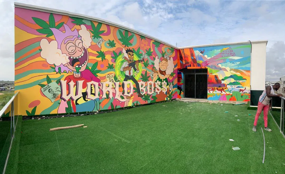 World Bo$$ mural extending across a private courtyard wall
